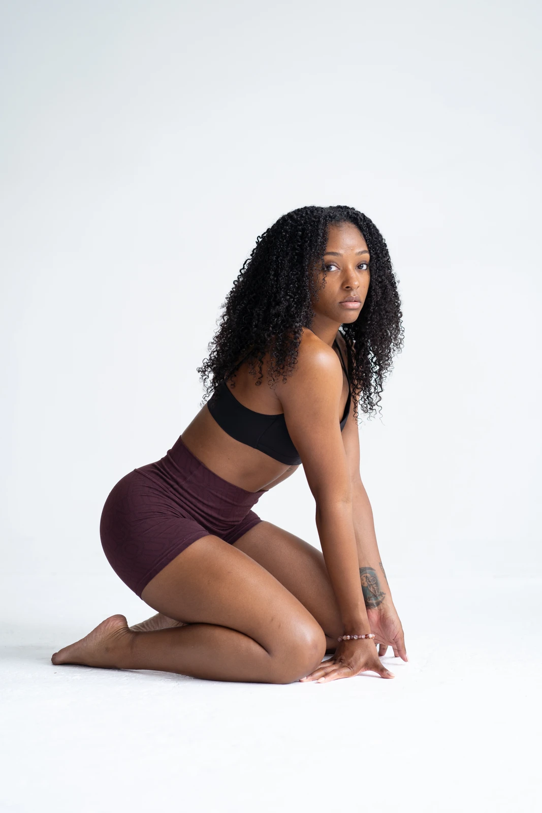 Unique Rembert seated in a studio wearing her signature black and maroon